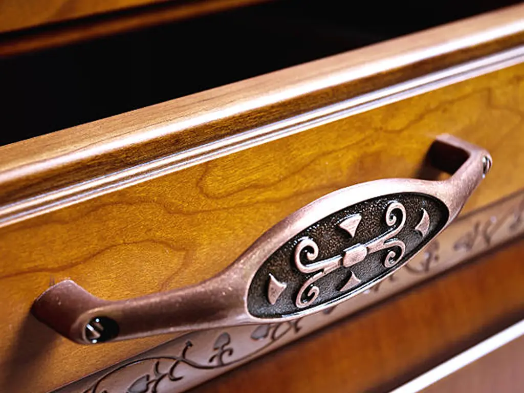 copper cabinet handle with wooden cabinet